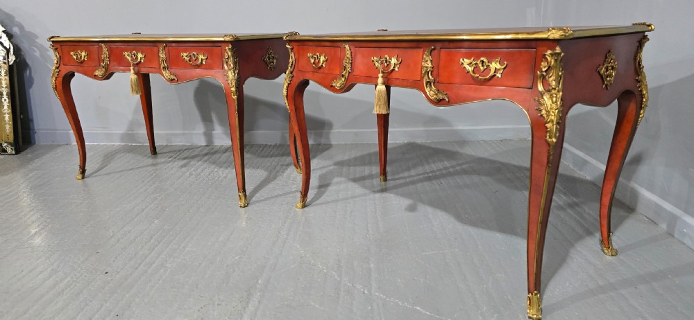 A pair of red lacquered French bureau plat writing desks featuring inset leather tops, three frieze drawers, and gilt bronze mounts on cabriole legs. View XIII