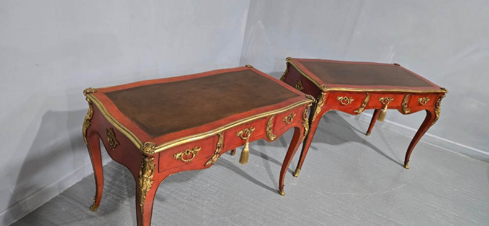 A pair of red lacquered French bureau plat writing desks featuring inset leather tops, three frieze drawers, and gilt bronze mounts on cabriole legs. View XVII