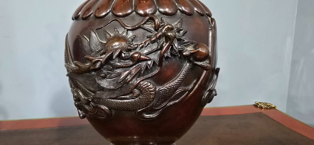 A pair of dark brown bronze urn-shaped table lamps featuring relief carvings of dragons and birds on turned wooden bases. View IV