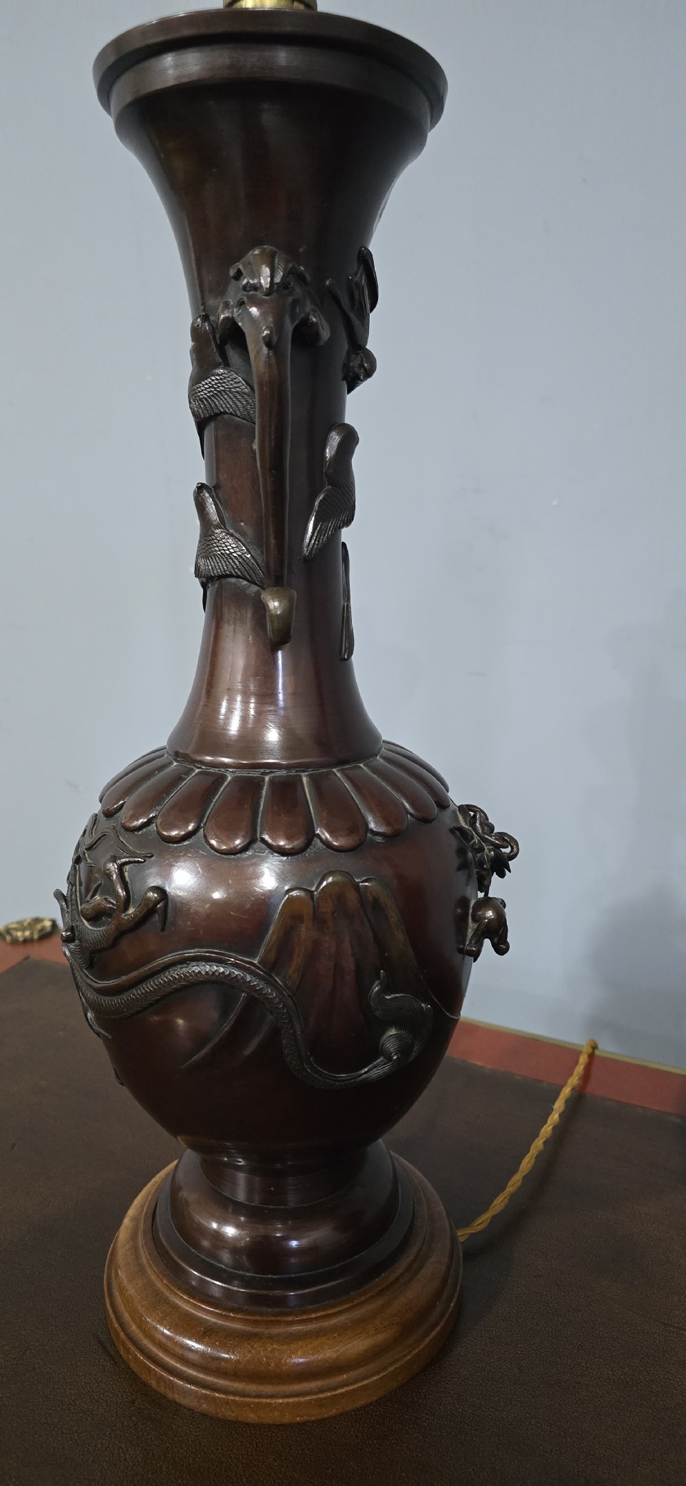 A pair of dark brown bronze urn-shaped table lamps featuring relief carvings of dragons and birds on turned wooden bases. View VI