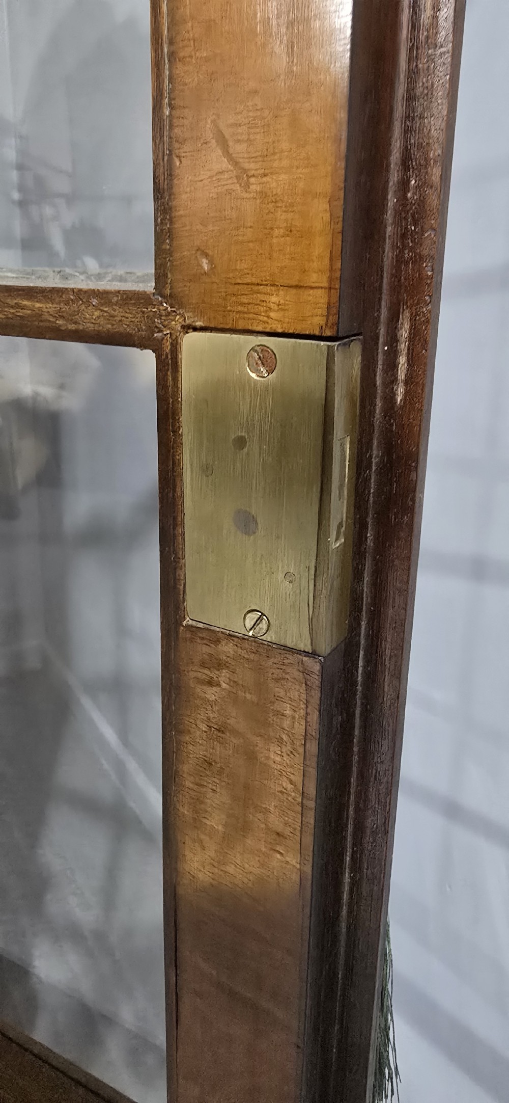 A double-door glazed burr walnut bookcase on stand featuring an arched pediment, astragal glazing bars, three lower drawers, and cabriole legs. View XVII