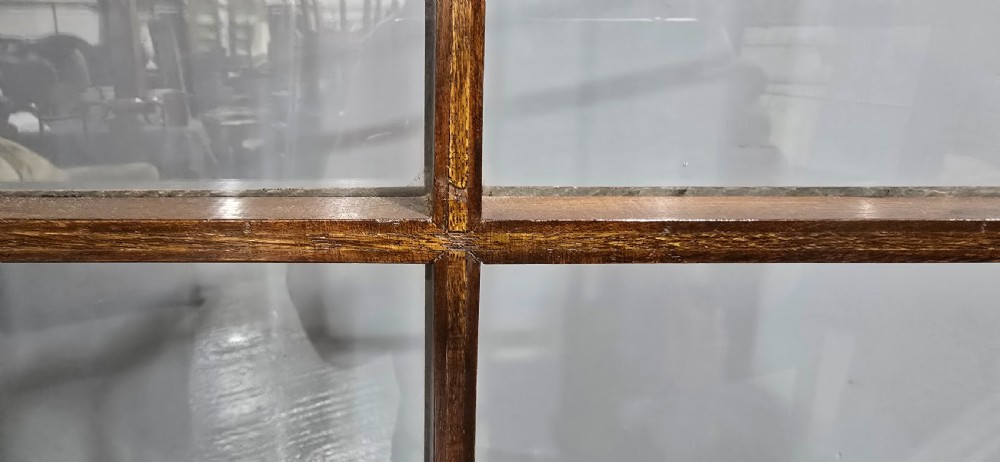 A double-door glazed burr walnut bookcase on stand featuring an arched pediment, astragal glazing bars, three lower drawers, and cabriole legs. View XVIII