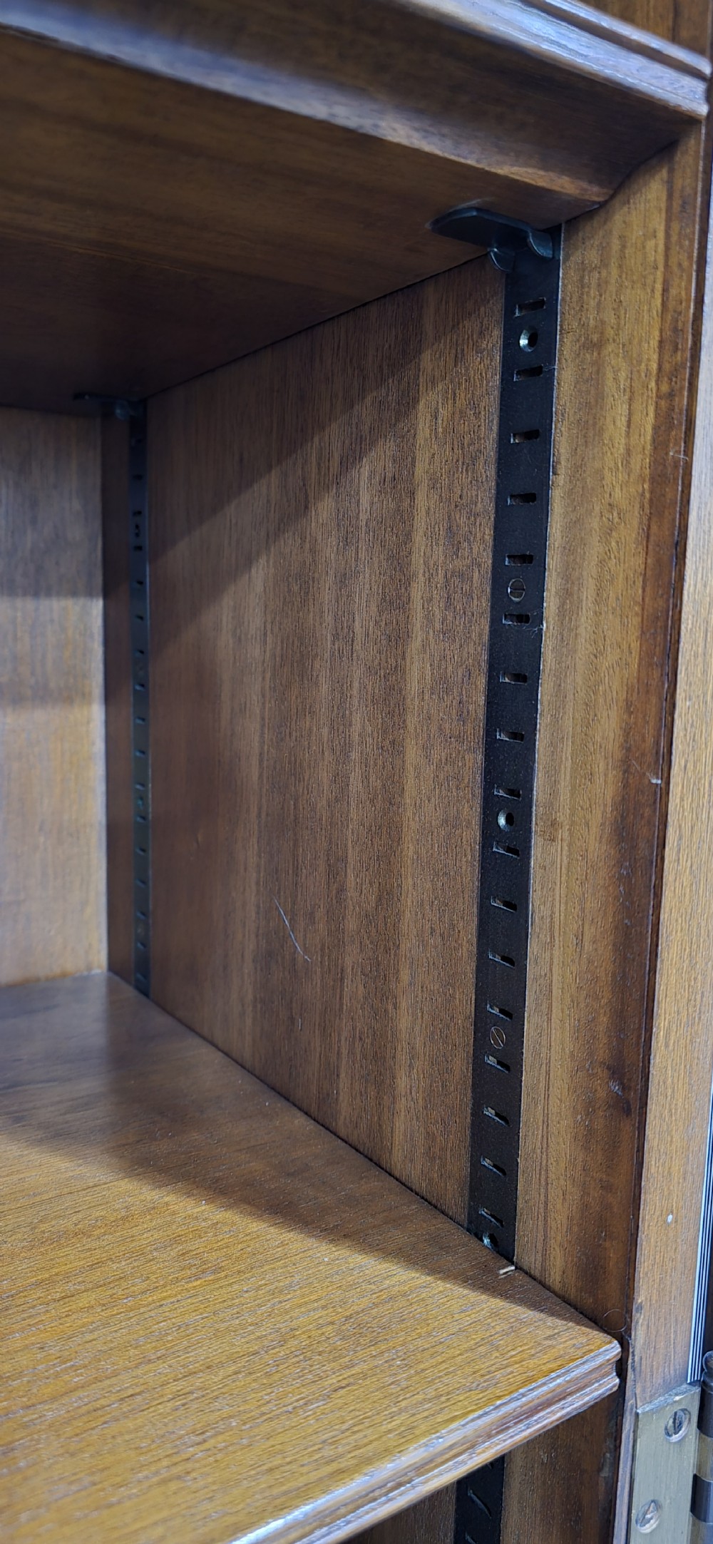 A double-door glazed burr walnut bookcase on stand featuring an arched pediment, astragal glazing bars, three lower drawers, and cabriole legs. View XX