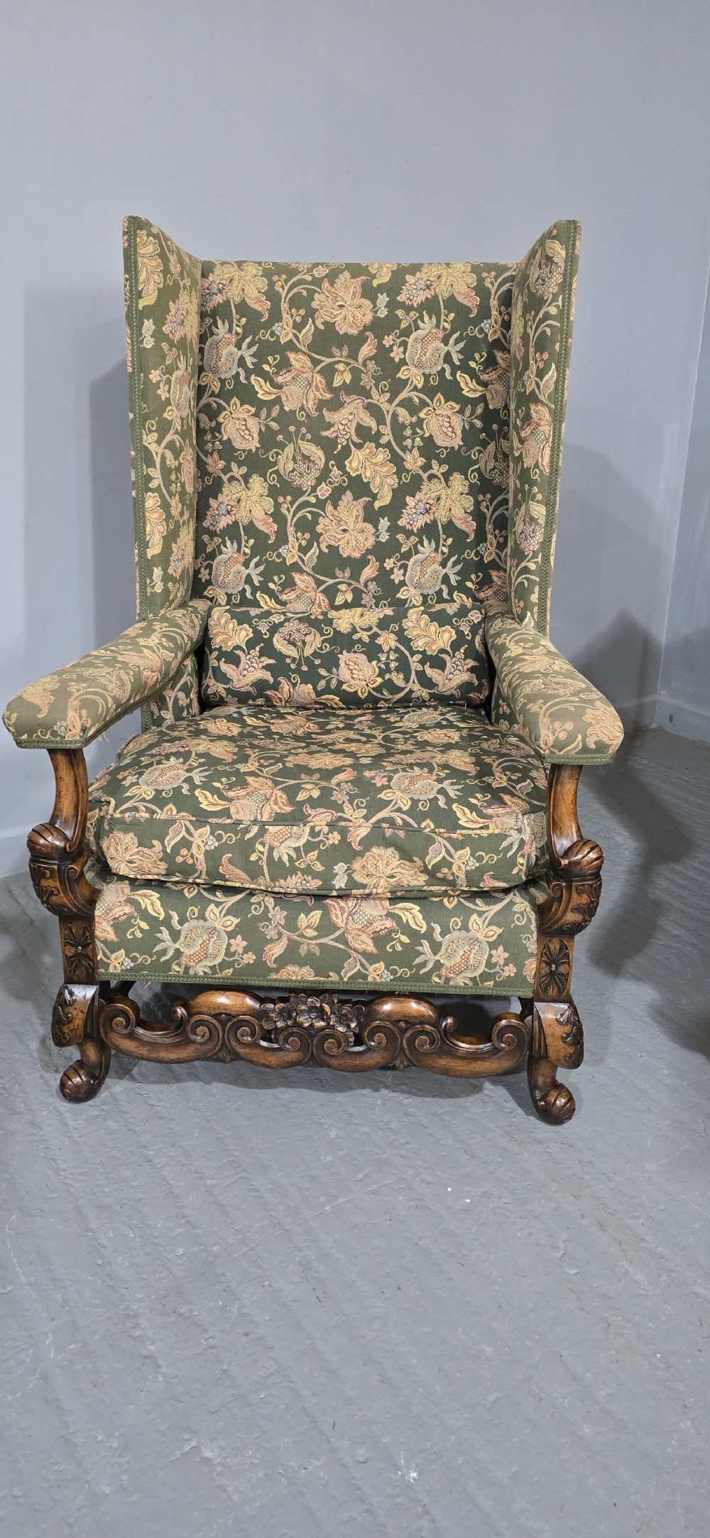 A pair of Jacobean revival armchairs with floral green tapestry upholstery and intricately carved walnut bases. View III