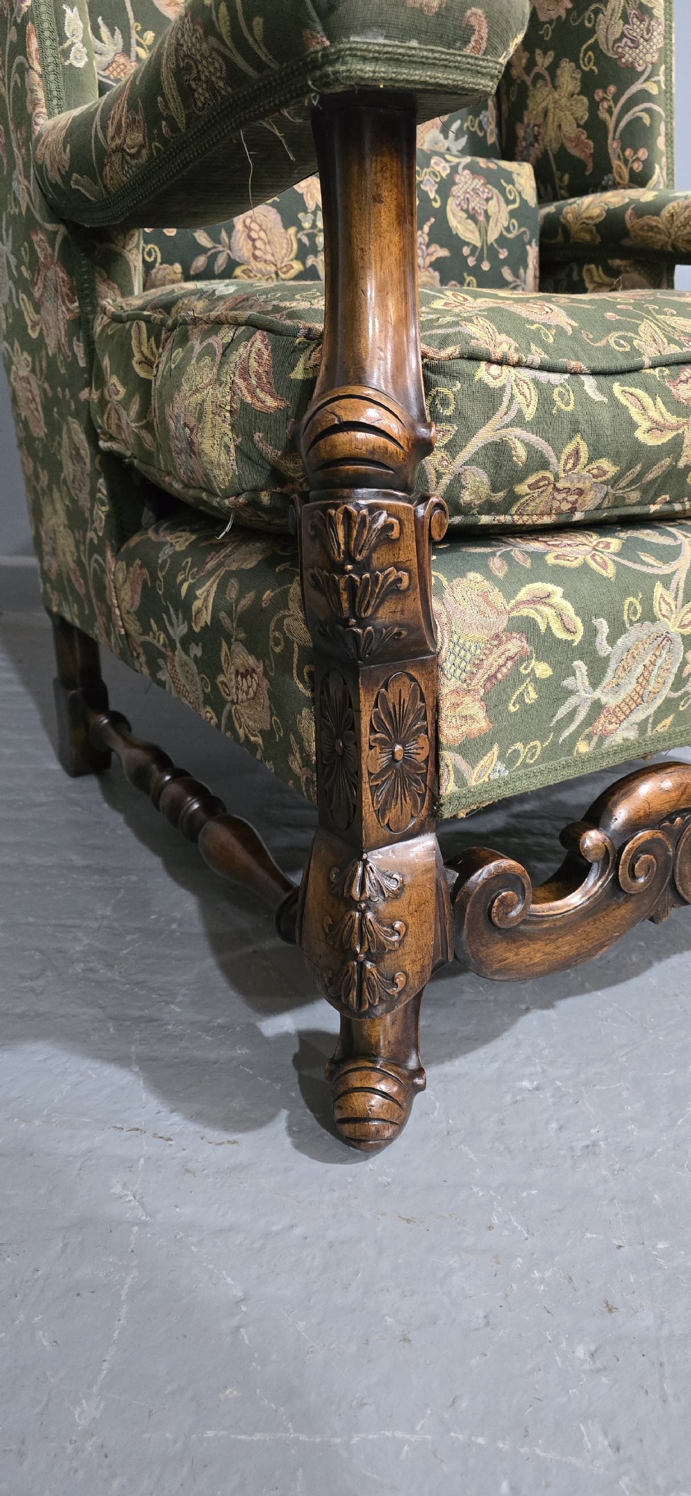 A pair of Jacobean revival armchairs with floral green tapestry upholstery and intricately carved walnut bases. View VI