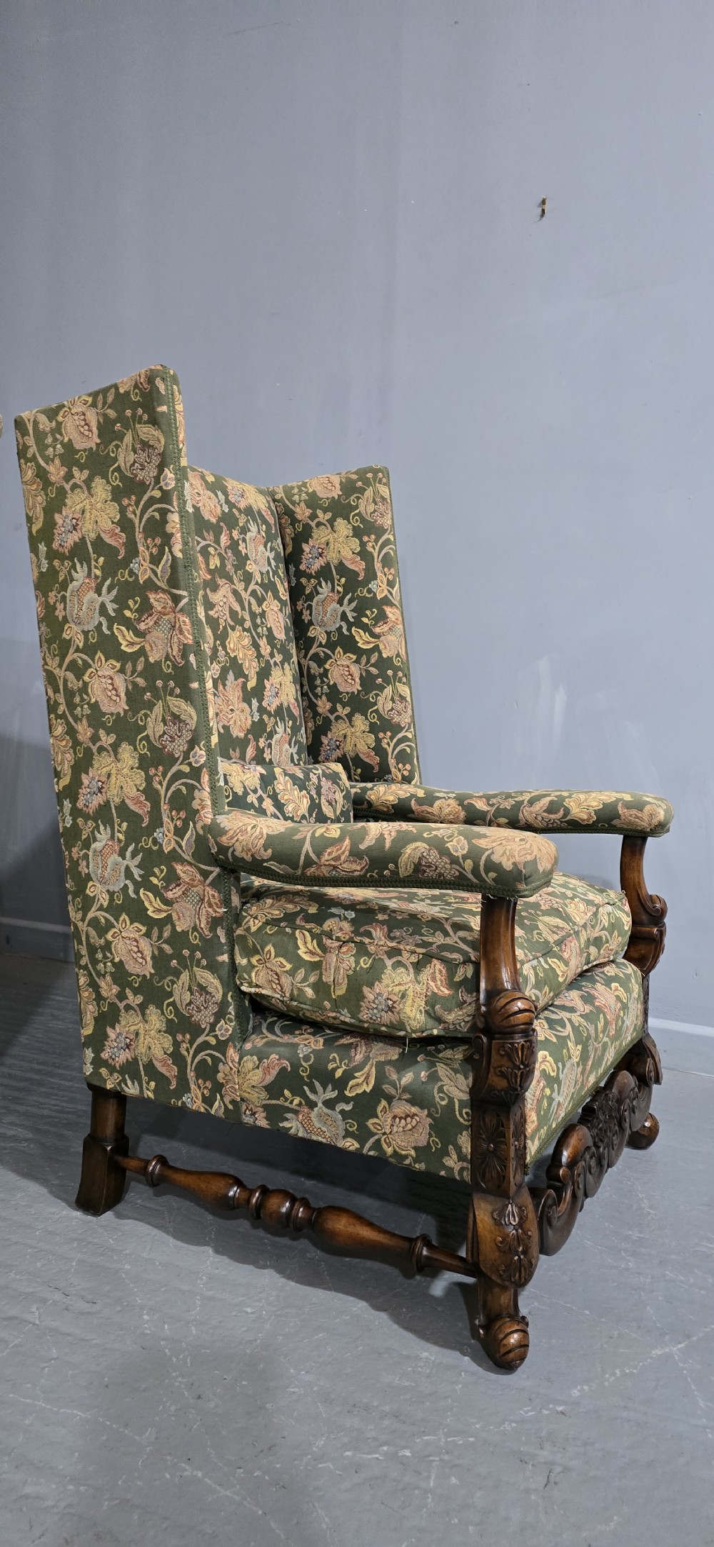 A pair of Jacobean revival armchairs with floral green tapestry upholstery and intricately carved walnut bases. View VII