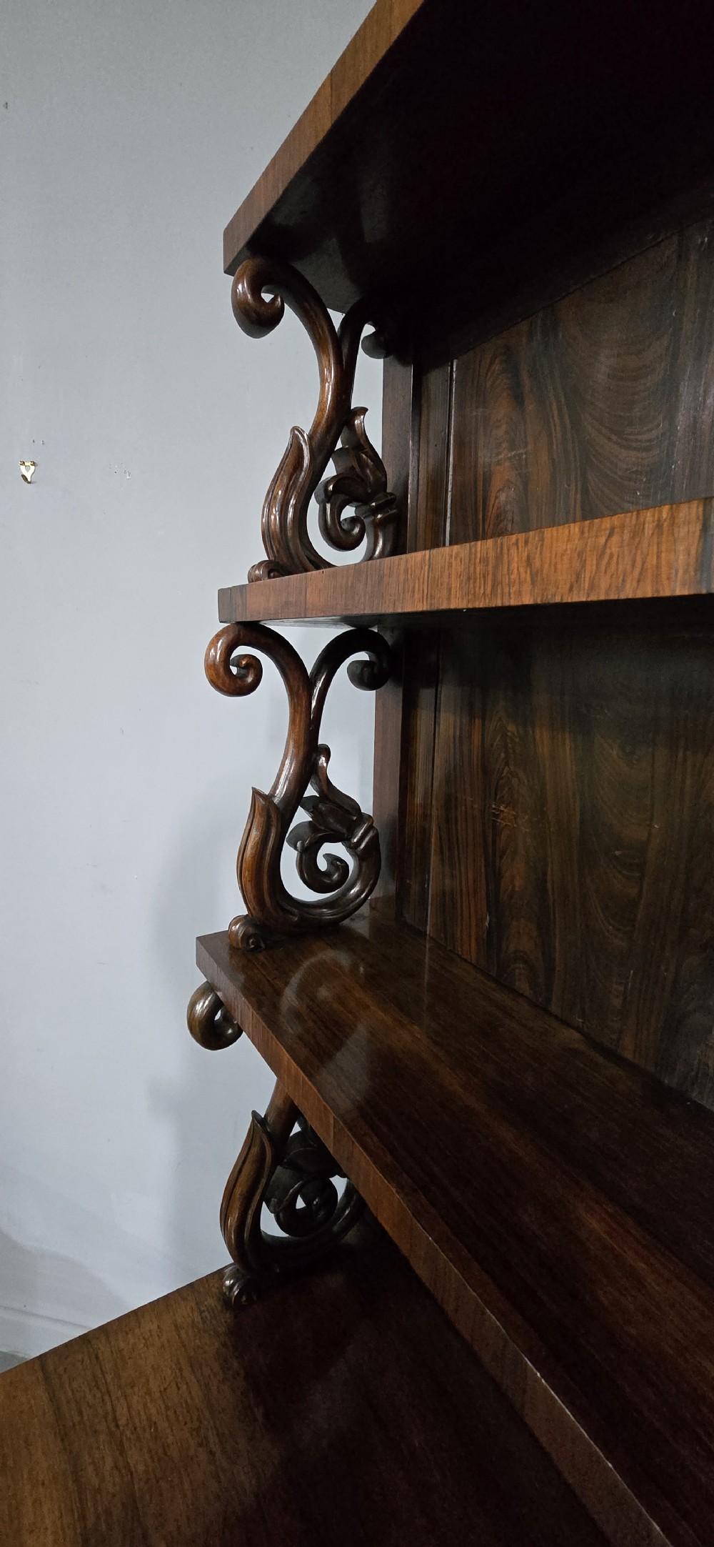 A large 19th-century William IV open mahogany waterfall bookcase with tiered graduated shelves filled with books and carved pilasters. View VII