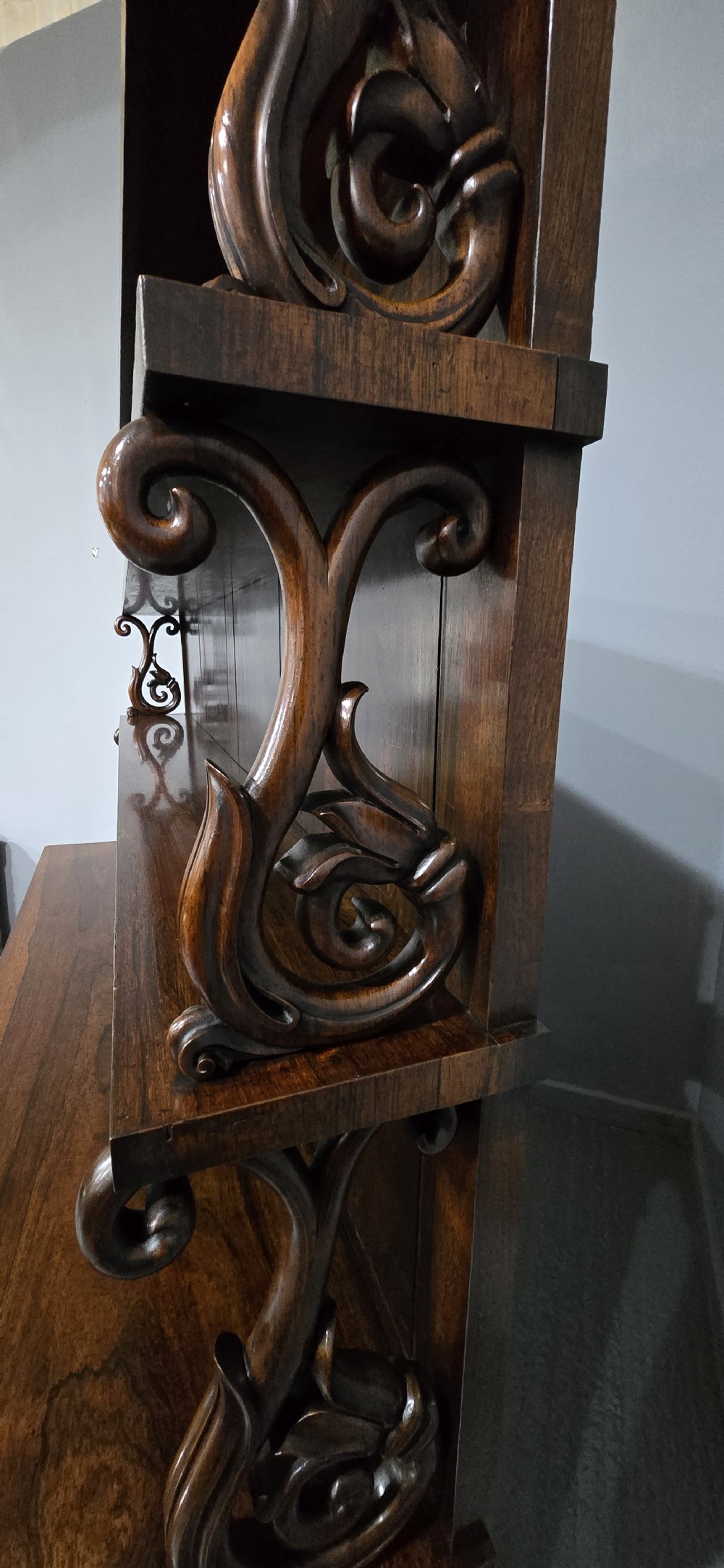 A large 19th-century William IV open mahogany waterfall bookcase with tiered graduated shelves filled with books and carved pilasters. View XIII