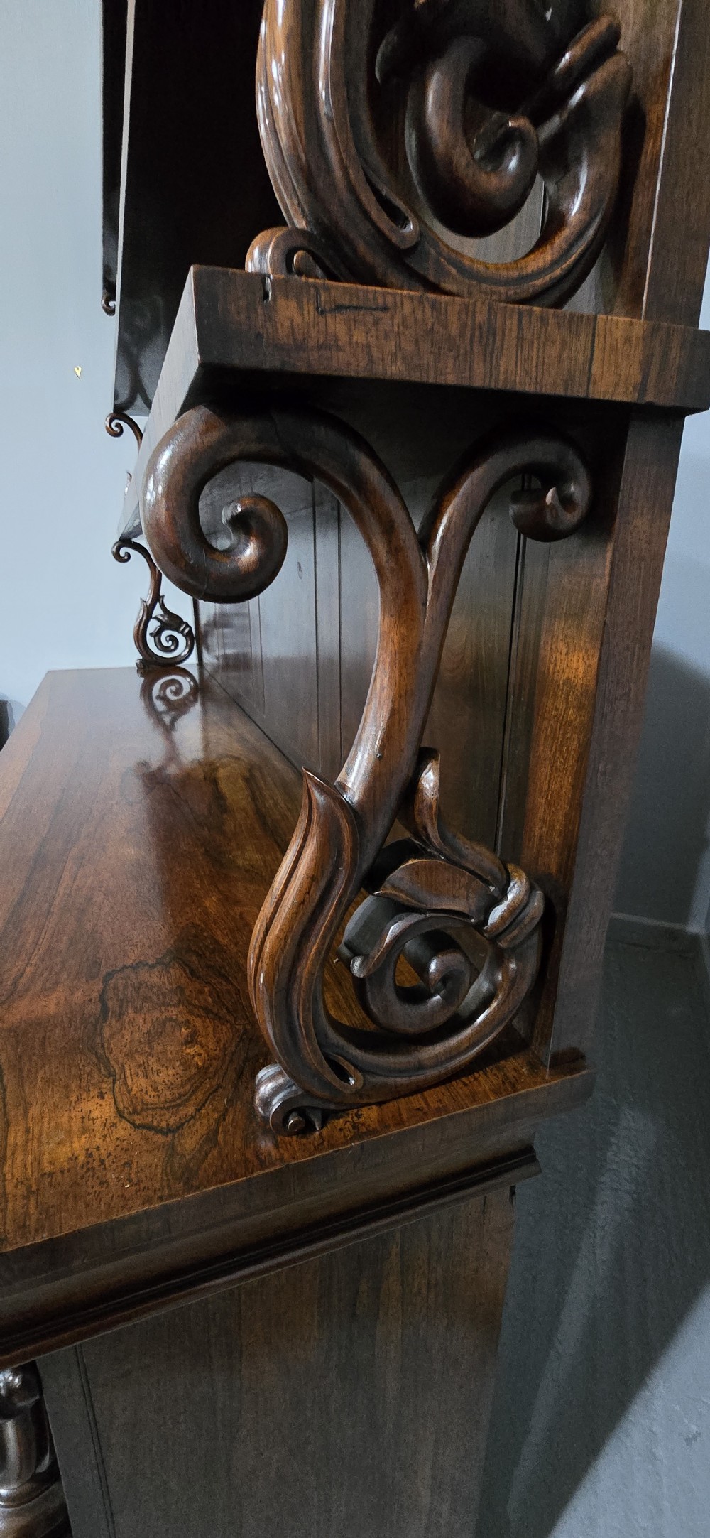 A large 19th-century William IV open mahogany waterfall bookcase with tiered graduated shelves filled with books and carved pilasters. View XIV