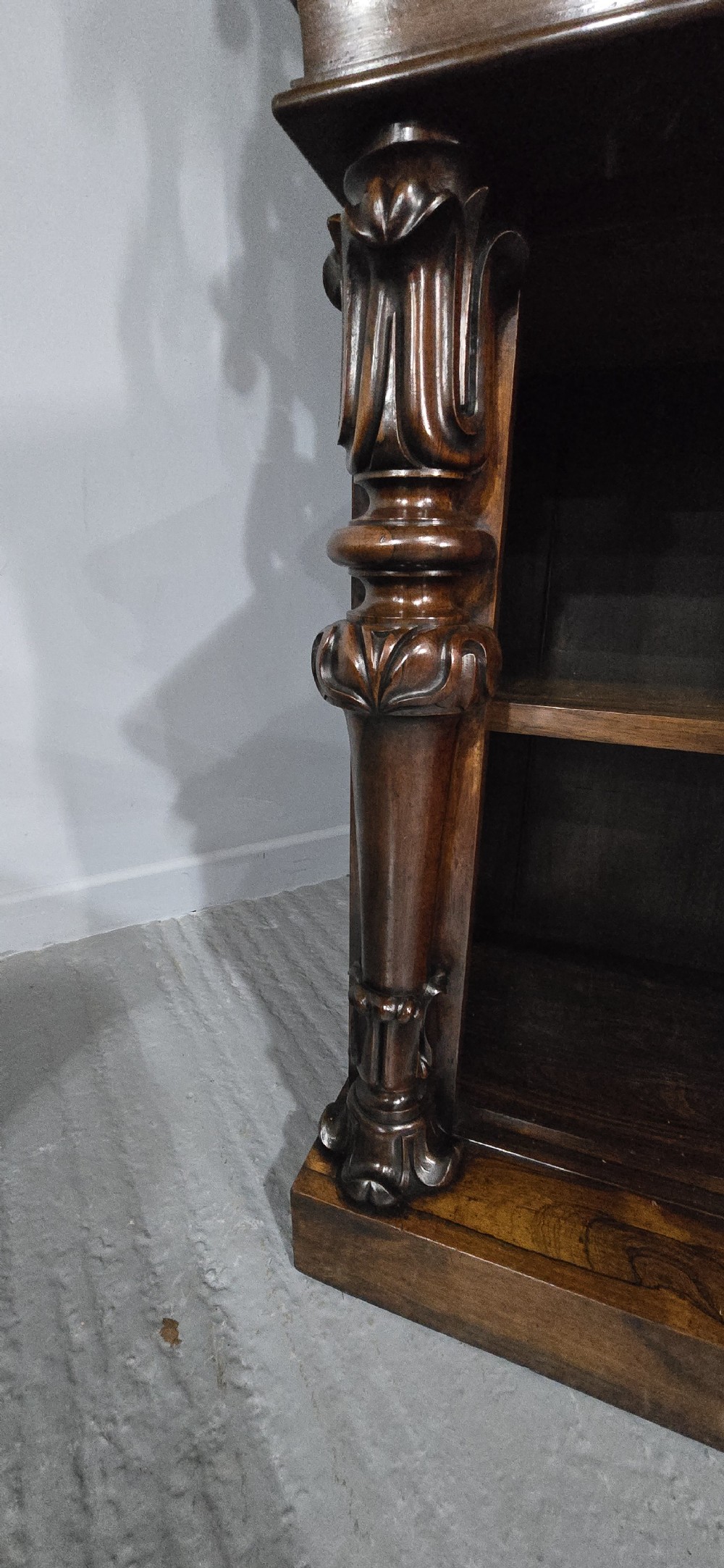 A large 19th-century William IV open mahogany waterfall bookcase with tiered graduated shelves filled with books and carved pilasters. View XV