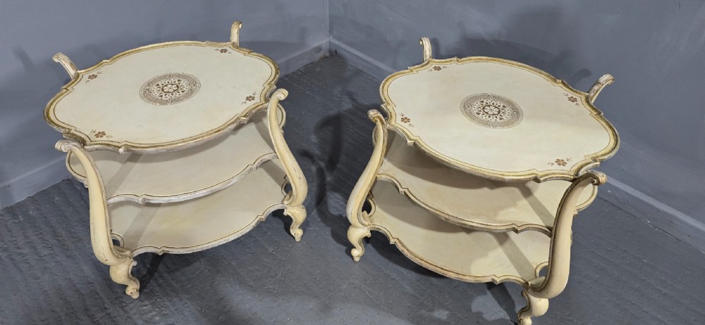 A pair of cream painted three-tier occasional lamp tables with cabriole legs and painted floral medallion tops. View II