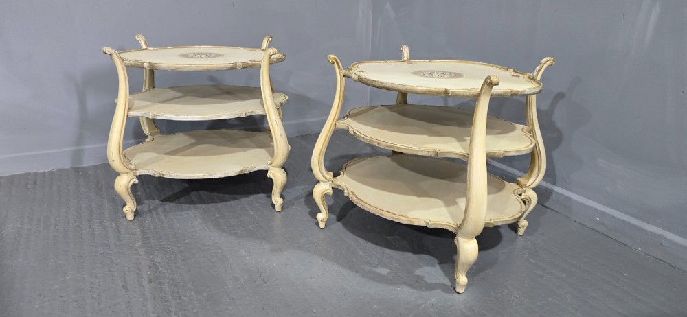 A pair of cream painted three-tier occasional lamp tables with cabriole legs and painted floral medallion tops. View III