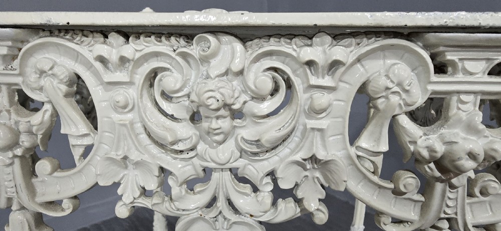 A three-tiered off-white painted cast iron jardiniere stand featuring elaborate openwork scrollwork trays, turned supports, and decorative feet. View VII