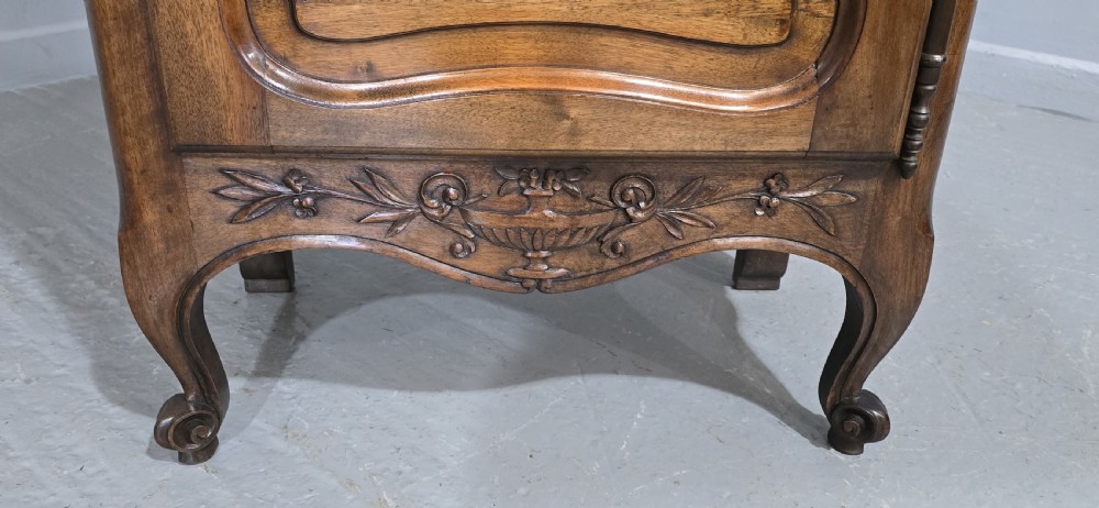 A French walnut single-door bookcase with a carved top frieze, glazed upper panel, solid lower panel, and carved cabriole feet. View III
