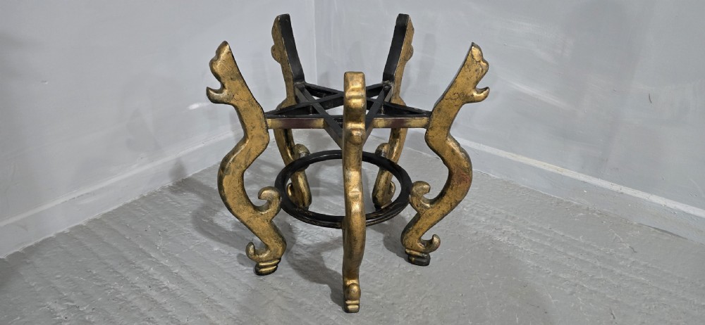 A large black lacquered oriental jardiniere decorated with gold floral and bird imagery, resting upon a carved gold giltwood dragon-form stand. View IX