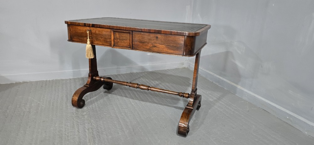A Regency dark rosewood writing sofa table with a leather-inset top, frieze drawers, scroll feet, and a turned stretcher. View III