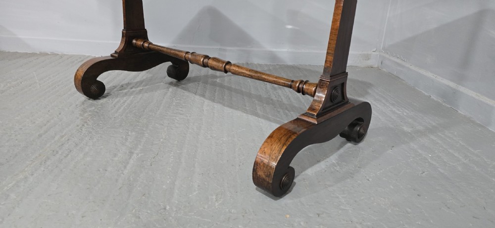 A Regency dark rosewood writing sofa table with a leather-inset top, frieze drawers, scroll feet, and a turned stretcher. View VII