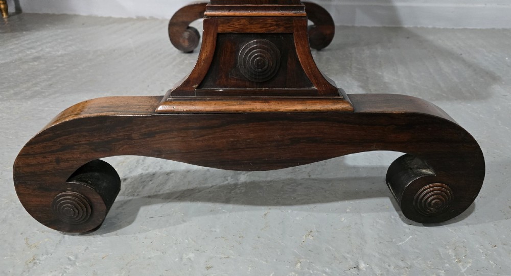 A Regency dark rosewood writing sofa table with a leather-inset top, frieze drawers, scroll feet, and a turned stretcher. View VIII