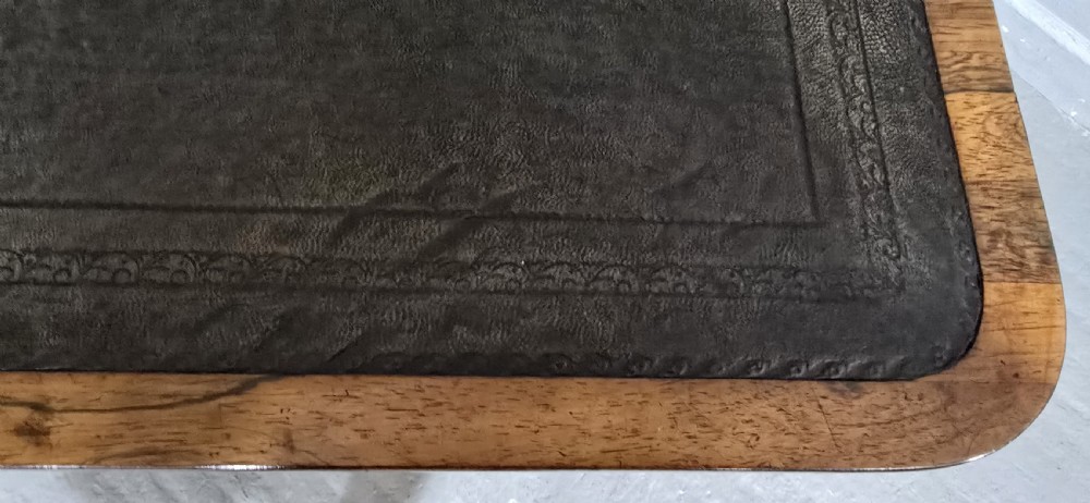 A Regency dark rosewood writing sofa table with a leather-inset top, frieze drawers, scroll feet, and a turned stretcher. View X