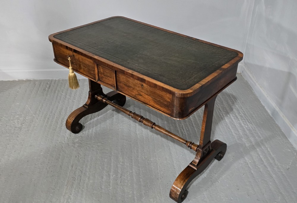 A Regency dark rosewood writing sofa table with a leather-inset top, frieze drawers, scroll feet, and a turned stretcher. View XI