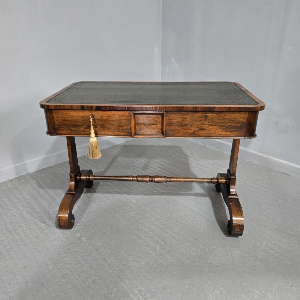A Regency dark rosewood writing sofa table with a leather-inset top, frieze drawers, scroll feet, and a turned stretcher. View XII