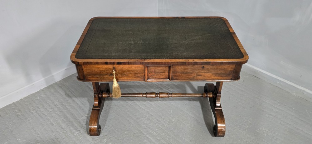 A Regency dark rosewood writing sofa table with a leather-inset top, frieze drawers, scroll feet, and a turned stretcher. View XIII