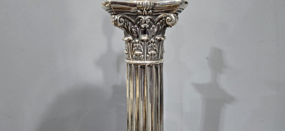An antique silver-plated table lamp designed as a fluted Corinthian column set upon a decorative square base. View IV