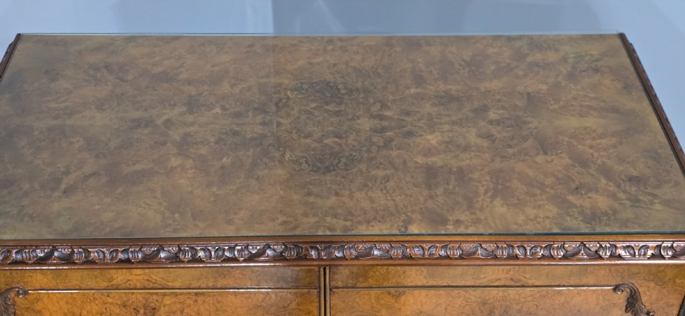 A freestanding burr walnut cocktail cabinet with double doors, carved shell apron, and cabriole legs. View V