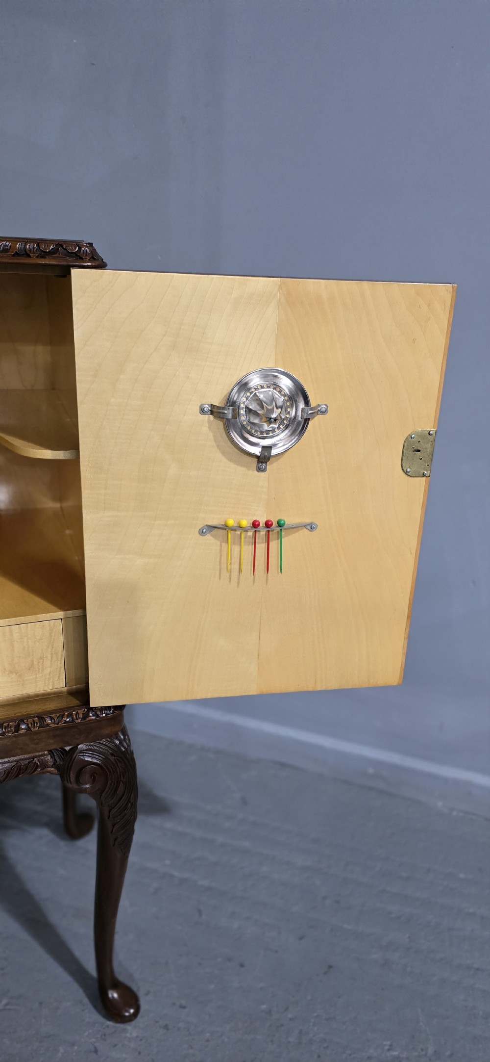 A freestanding burr walnut cocktail cabinet with double doors, carved shell apron, and cabriole legs. View IX