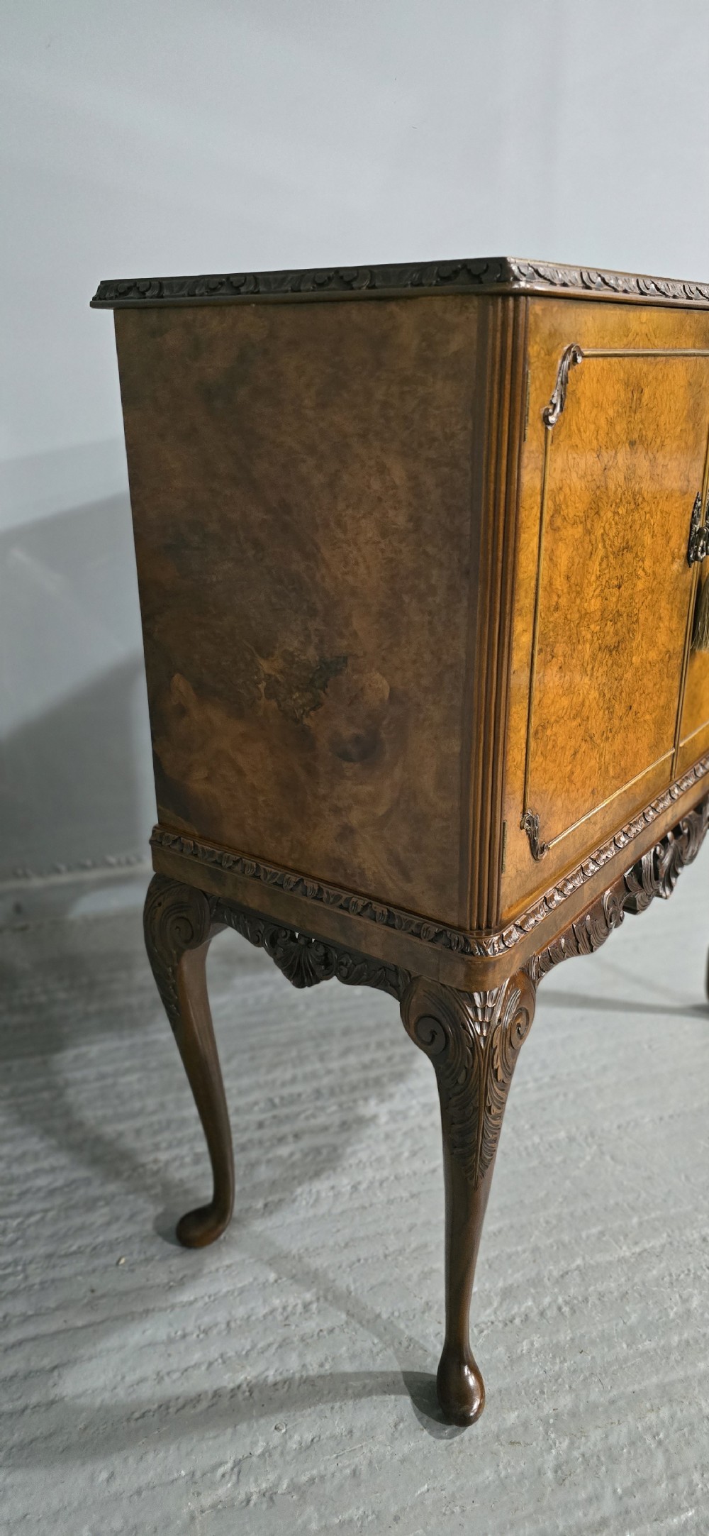 A freestanding burr walnut cocktail cabinet with double doors, carved shell apron, and cabriole legs. View XI