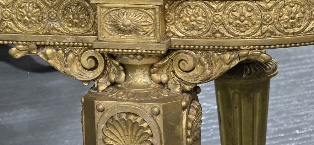 A Victorian giltwood console table featuring a white marble top, mirrored back panel, fluted tapered legs, and a carved rosette frieze. View XIII