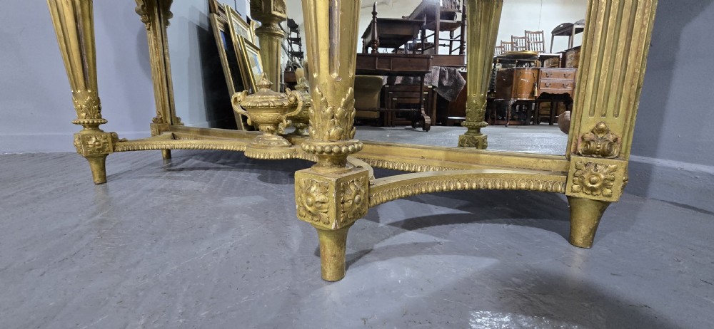 A Victorian giltwood console table featuring a white marble top, mirrored back panel, fluted tapered legs, and a carved rosette frieze. View XIV