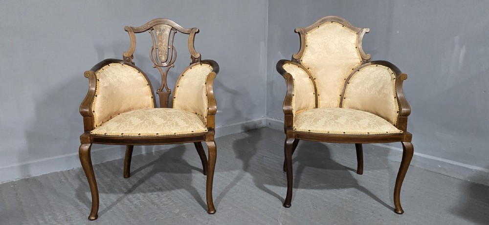 A pair of Edwardian Art Nouveau mahogany armchairs featuring cream floral upholstery, decorative back splats with marquetry inlay, and curved legs. View III