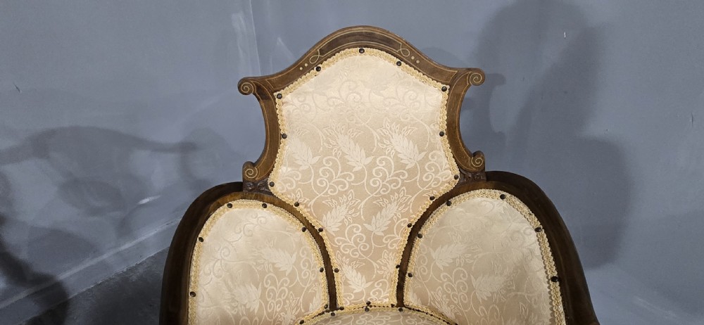 A pair of Edwardian Art Nouveau mahogany armchairs featuring cream floral upholstery, decorative back splats with marquetry inlay, and curved legs. View VI