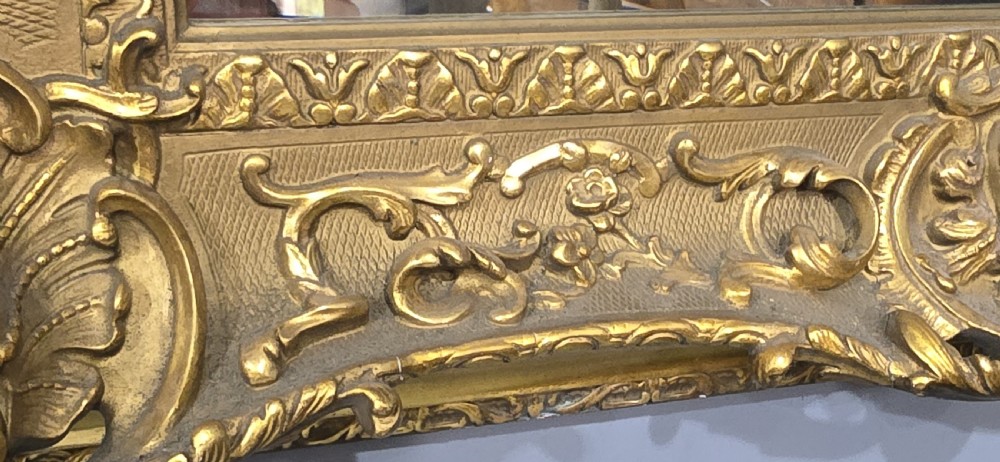 A pair of matching rectangular wall mirrors featuring gold giltwood frames embellished with ornate shell motifs and relief scrollwork. View VI