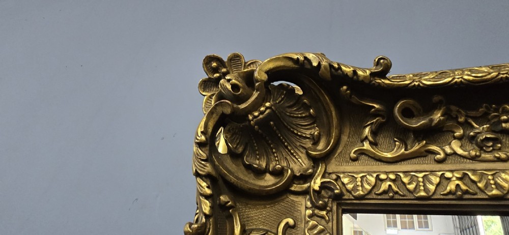 A pair of matching rectangular wall mirrors featuring gold giltwood frames embellished with ornate shell motifs and relief scrollwork. View XIV