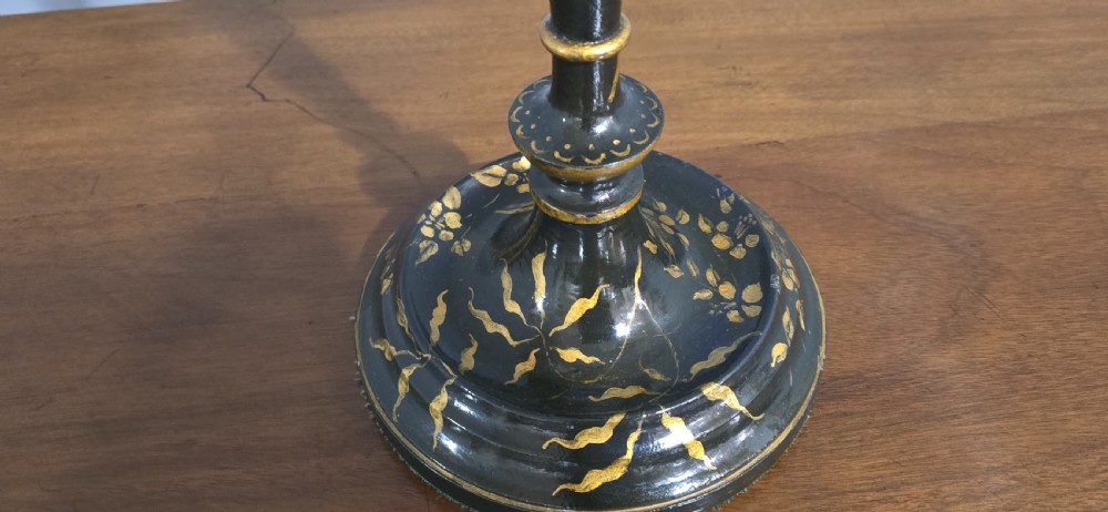 A tall black lacquered table lamp with gilded chinoiserie floral patterns and a pleated light grey fabric shade. View III