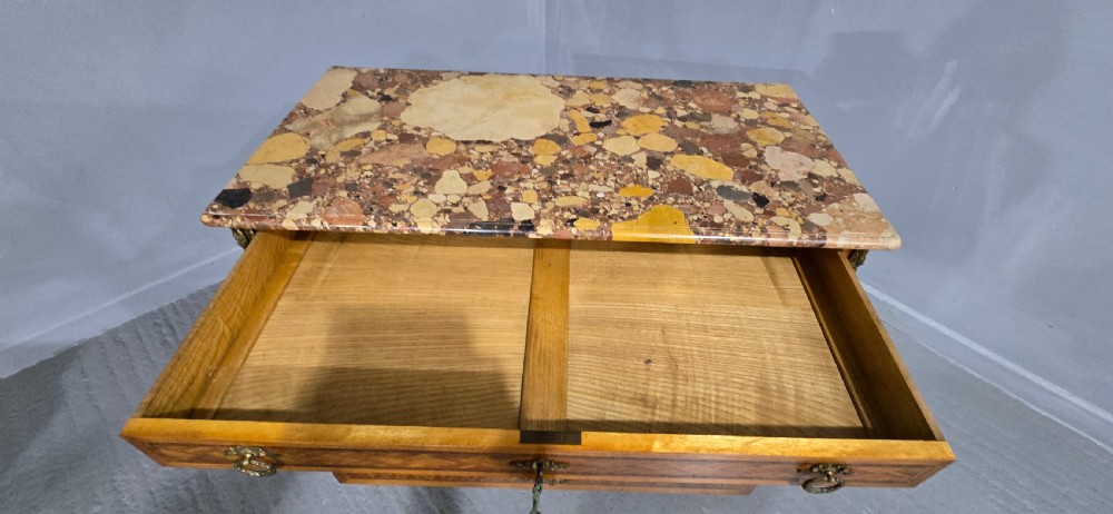 A French satinwood commode chest featuring herringbone parquetry veneer, a variegated marble top, and decorative gilt-bronze mounts. View XII