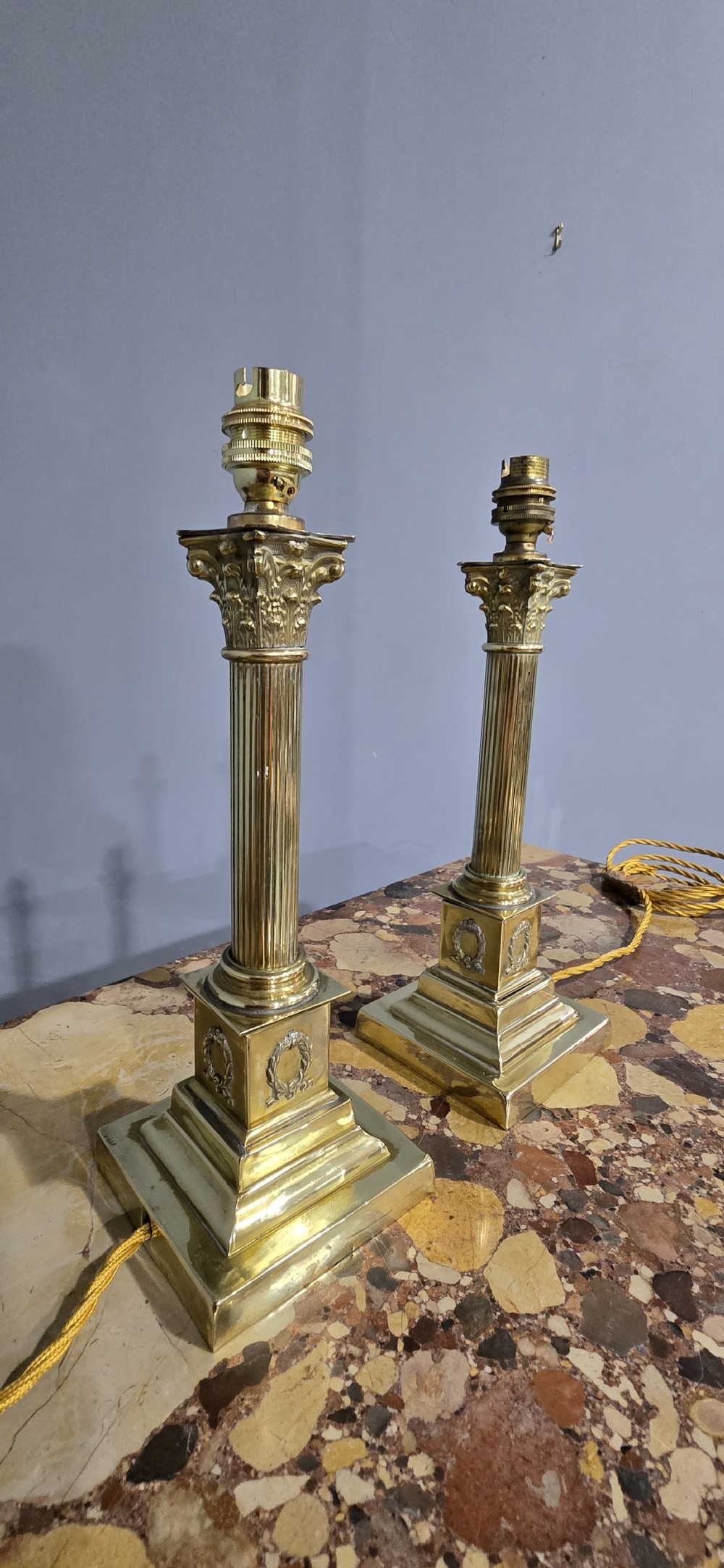 A pair of antique cast brass table lamps styled as classical fluted Corinthian columns with stepped bases. View VII