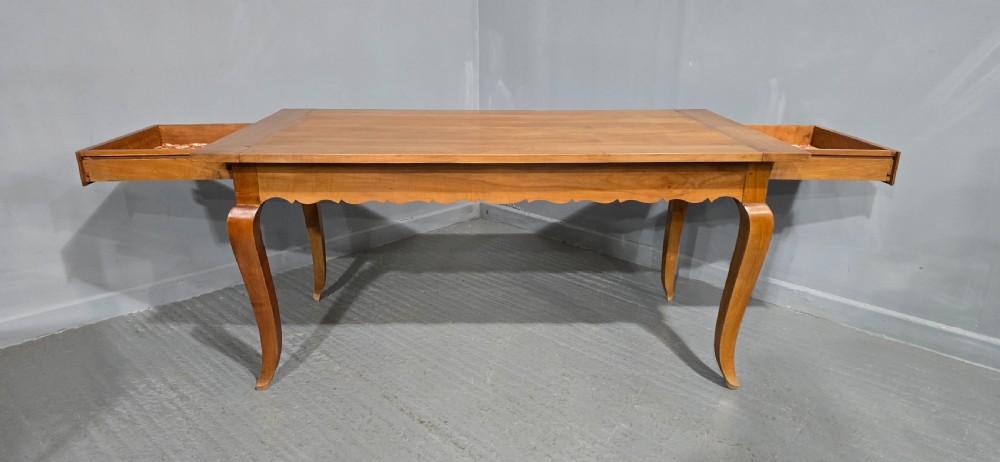 A French provincial solid cherry dining table featuring cabriole legs and a scalloped apron. View V