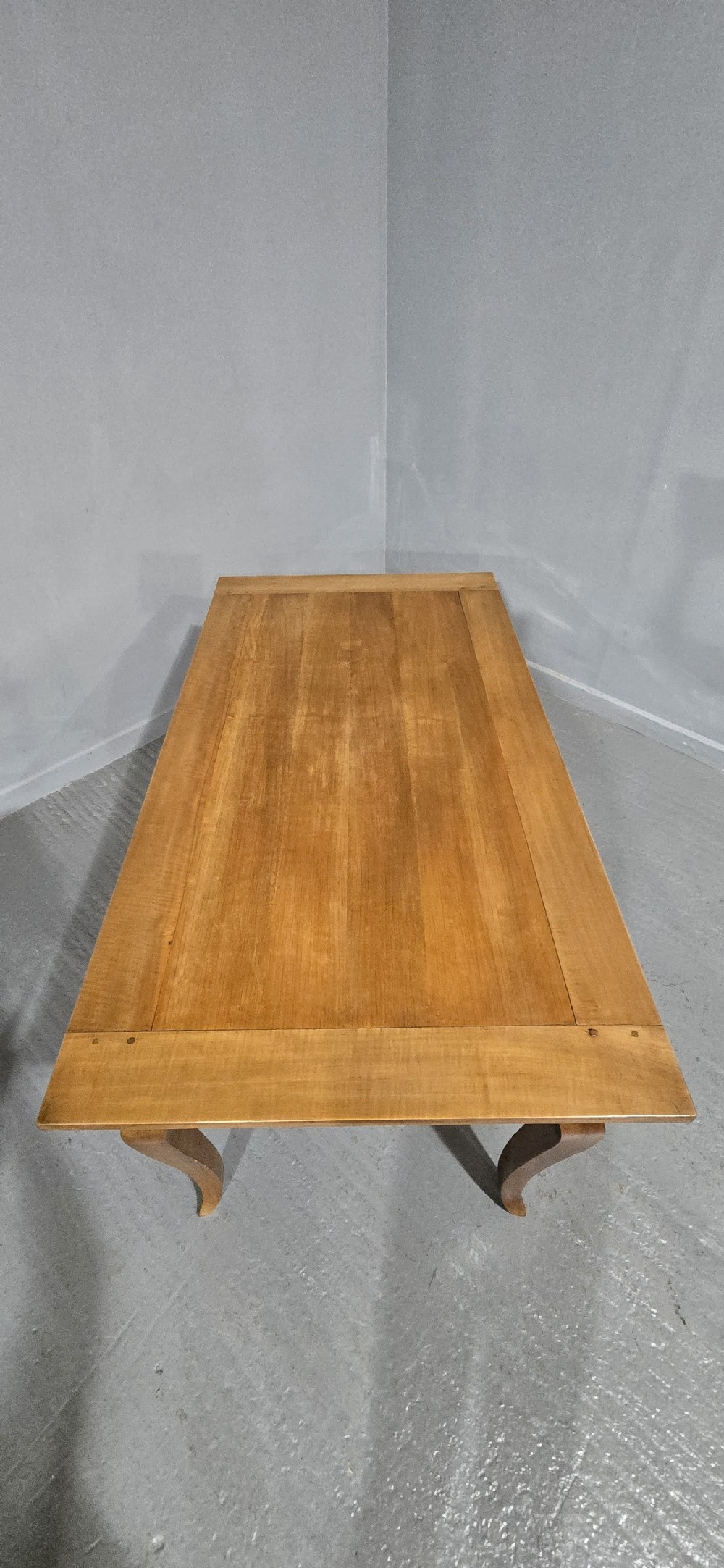 A French provincial solid cherry dining table featuring cabriole legs and a scalloped apron. View VI