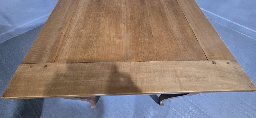 A French provincial solid cherry dining table featuring cabriole legs and a scalloped apron. View VII