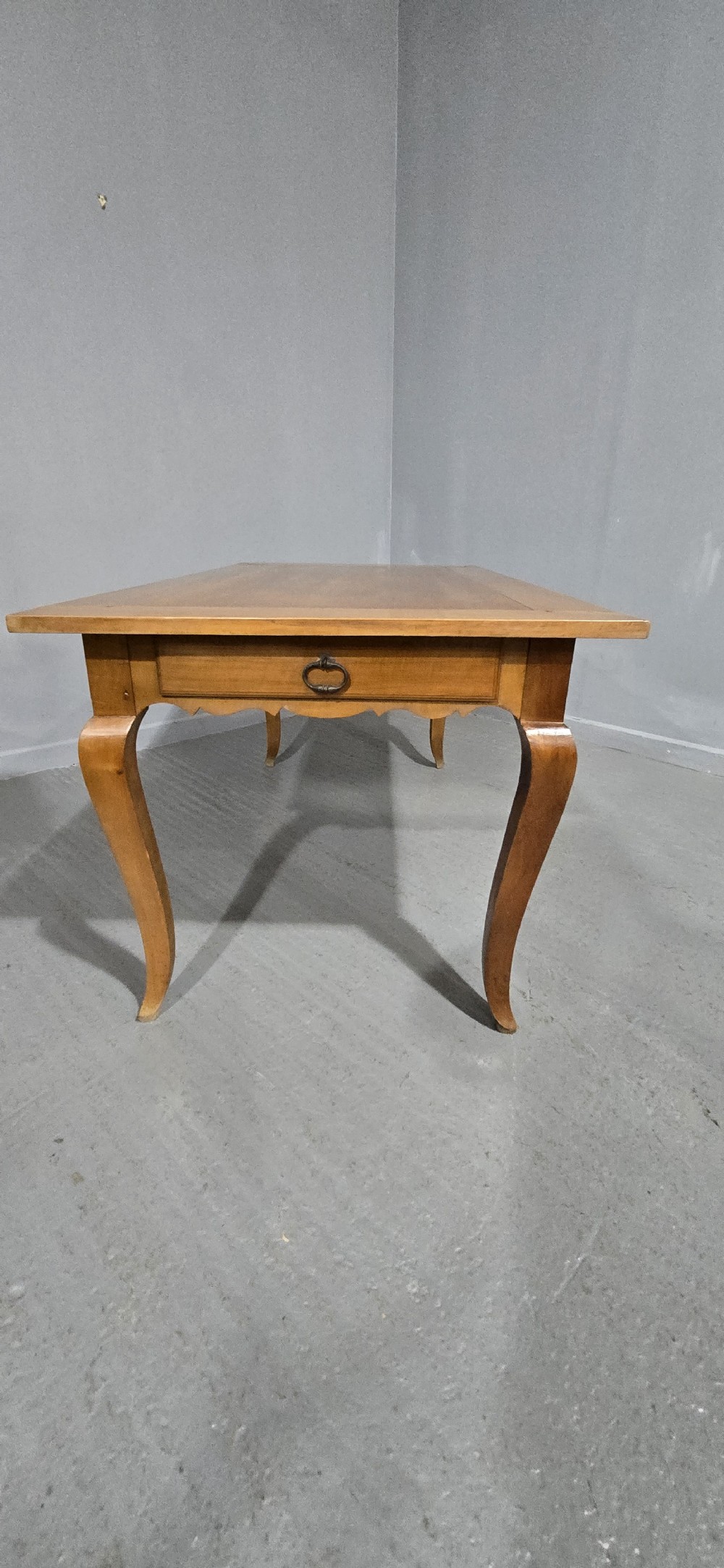 A French provincial solid cherry dining table featuring cabriole legs and a scalloped apron. View VIII