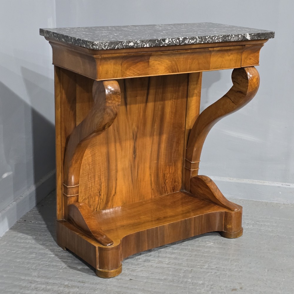 A nineteenth-century walnut console table featuring a grey-and-white mottled marble top supported by scrolling front legs and a solid base.