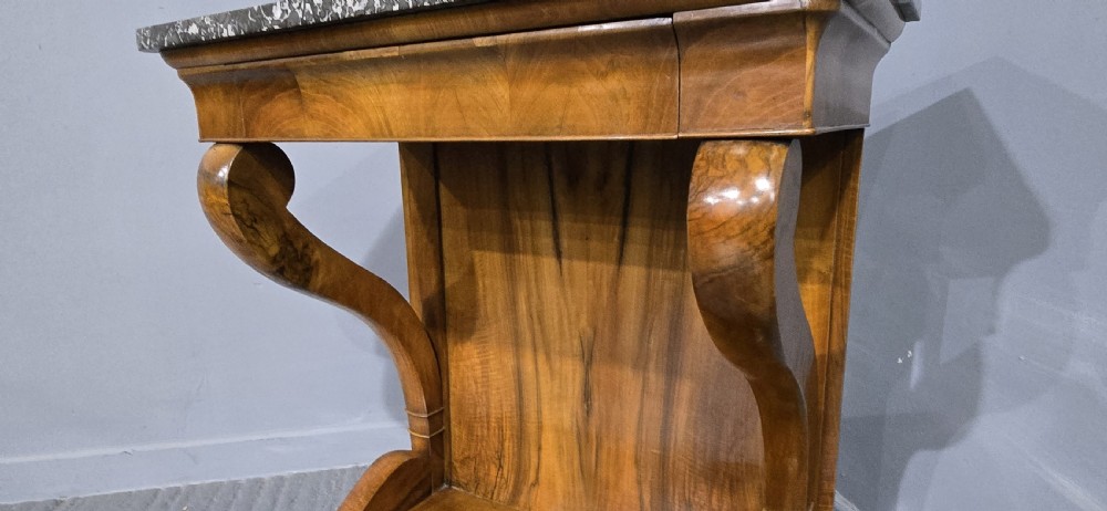 A nineteenth-century walnut console table featuring a grey-and-white mottled marble top supported by scrolling front legs and a solid base. View VI