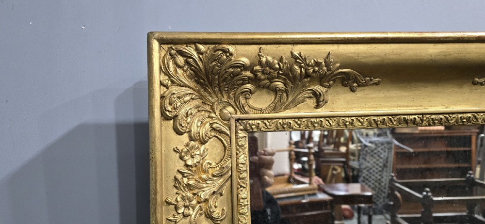 A pair of square antique early Victorian mirrors featuring ornate gold gilt frames with deeply moulded corner scrolls. View VI