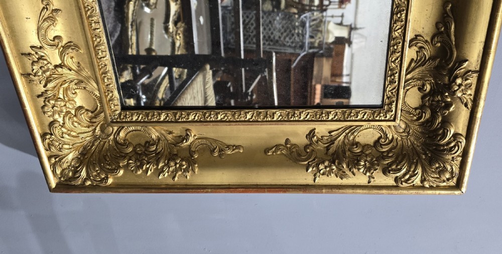 A pair of square antique early Victorian mirrors featuring ornate gold gilt frames with deeply moulded corner scrolls. View VII