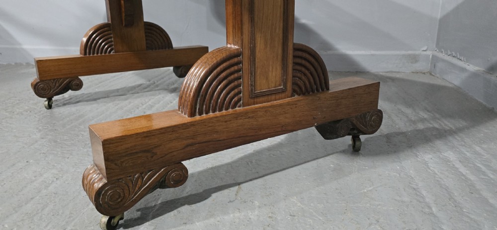 A Regency rosewood sofa table with two frieze drawers, brass line inlay, drop leaves, carved rosette corners, and reeded legs on brass castors. View XVII
