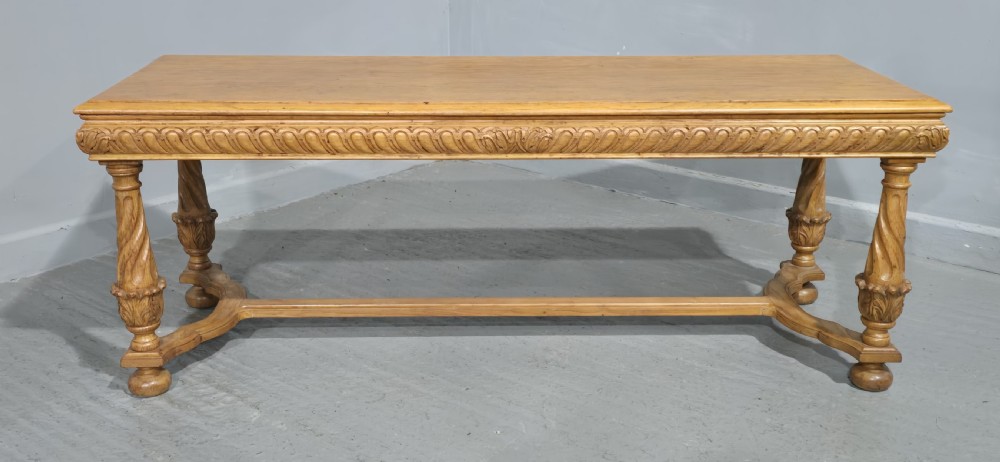 A rectangular carved light oak footboard bench featuring a gadrooned edge, turned twist legs with acanthus leaf details, and a lower connecting stretcher. View II