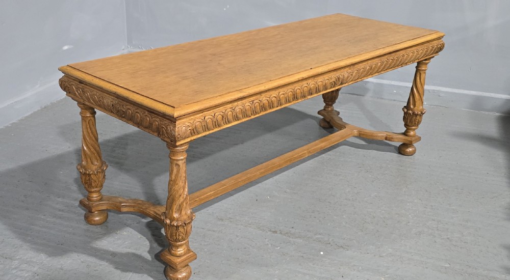 A rectangular carved light oak footboard bench featuring a gadrooned edge, turned twist legs with acanthus leaf details, and a lower connecting stretcher. View VIII